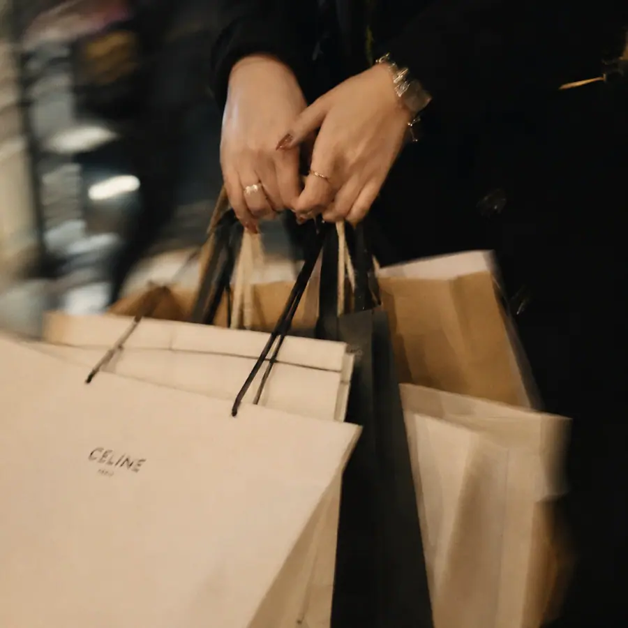Person carrying several shopping bags